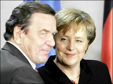 Incoming German Chancellor Angela Merkel (R) looks at outgoing Chancellor Gerhard Schroeder during a handing over ceremony at the chancellery in Berlin.