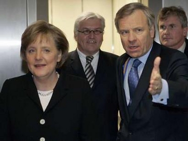 German Chancellor Angela Merkel (L) and Foreign Minister Frank-Walter Steinmeier (C) stand with NATO Secretary-General Jaap de Hoop Scheffer (R) during their meeting in Brussels November 23, 2005.