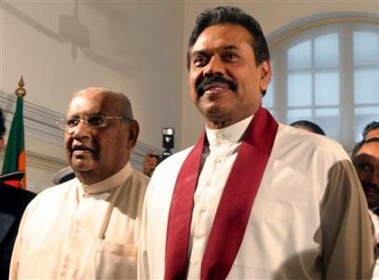 Newly-appointed Sri Lankan Prime Minister Ratnasiri Wickremanayake (L) and President Mahinda Rajapakse are seen after Wickremanayake was sworn in at the President House in Colombo November 21, 2005.