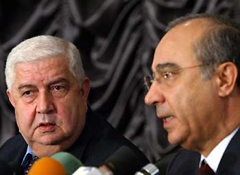Syrian Deputy Foreign Minister Walid al-Moualem (L) and Riad al-Daoudi, the legal advisor of the Syrian Foreign Ministry, attend a news conference in Damascus November 25, 2005.