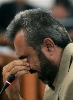 Ahmad Hassan Mohammed Al Dujaili cries while testifying in open court during the trial of former Iraqi president Saddam Hussein in Baghdad's heavily fortified Green Zone, Monday Dec. 5, 2005.