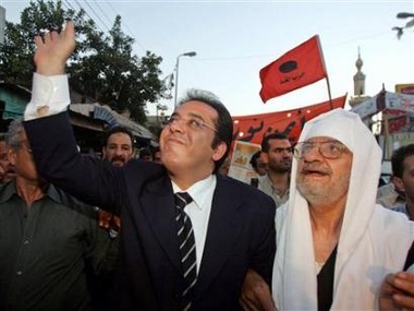 Ayman Nour greets a crowd before a speech in Tanta, north of Cairo, August 23, 2005.
