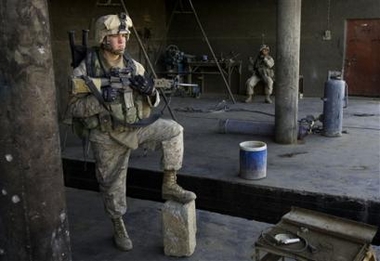 U.S. Marine Lance Cpl. Philip Schrock of Greenwood, Delaware pauses during a patrol in Karabilah, Iraq, seven miles from Syria, Wednesday, Dec. 7, 2005. 