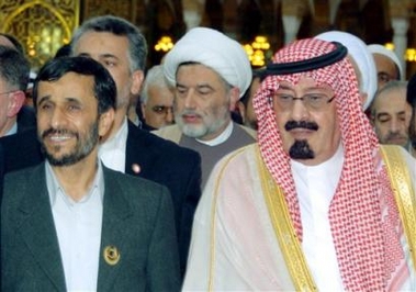 Saudi Arabia's King Abdullah, right, and Iranian President Mahmoud Ahmadinejad, left, walk in front of unidentified delegates in Mecca, Saudi Arabia, Thursday, Dec. 8, 2005.