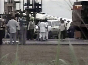 An image taken from television footage shows rescue workers at a crash site after a plane crash in Nigeria December 10, 2005.