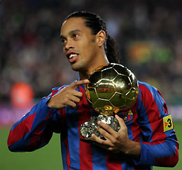 Barcelona's Brazlian soccer player Ronaldinho shows his Ballon d'Or (Golden Ball) award, as European Footballer of the Year, before their Spanish First Division soccer match against Sevilla at Nou Camp Stadium in Barcelona, Spain December 11, 2005