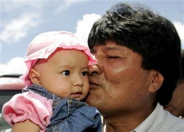 Bolivian presidential candidate Evo Morales of the Movement Toward Socialism (MAS) party kisses a baby as he visits a polling station in Cochabamba, central Bolivia, December 18, 2005.