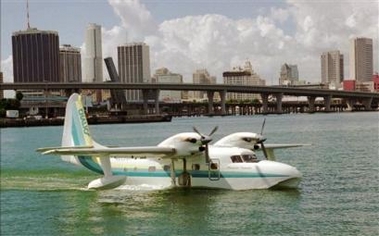 A twin-engine Grumman G-73T Turbine Mallard seaplane of Chalk's Ocean Airways arrives from Bimini with Miami's skyline in the background Tuesday, Jan. 30, 1996.