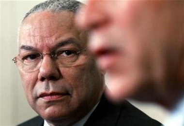 Secretary of State Colin Powell, left, listens to President Bush speak to reporters, in this Jan. 10, 2005 file photo, in the Oval Office.