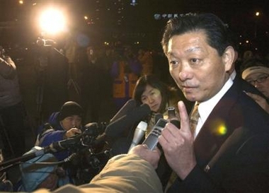 Song Il Ho, North Korea's chief representative, right, gestures as he speaks to journalists in Beijing, China, Sunday, Dec. 25, 2005. 