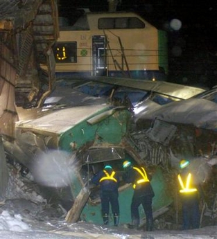 Rescuers are on the scene of derailed express train to rescue trapped passengers in Shonai Cho, northern Japan, Sunday, Dec 25, 2005. 