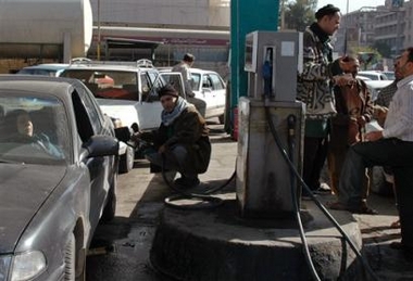 Motorists queue for petrol at a gas station in Baghdad, Iraq, Friday, Dec. 30, 2005