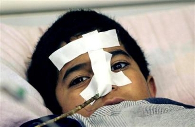 A young victim of a suicide bomber's attack lies in a bed at the Karbala hospital, Thursday, Jan. 5, 2006, in Karbala, Iraq.