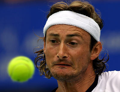 Spain's Juan Carlos Ferrero watches the ball during his first-round match against Australia's Chris Guccione at the Sydney International Tennis tournament January 9, 2006. [Reuters]