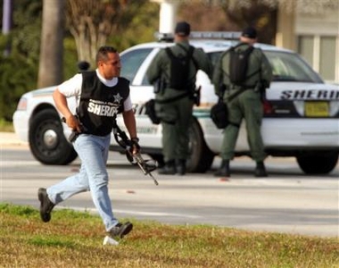 Law enforcement officers move into position during a standoff at the Mercantile Bank in Kissimmee, Fla. on Tuesday, Jan. 10, 2006.