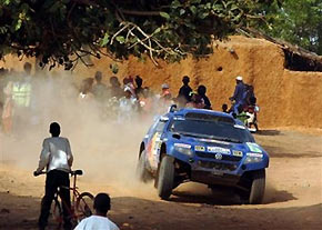 Spanish driver Carlos Sainz and German co-driver Andreas Schulz steer their Volkswagen Touareg through a village during the tenth stage of the Dakar Rally between Kiffa, Mauritania, and Kayes, Mali, Tuesday Jan 10, 2006. 