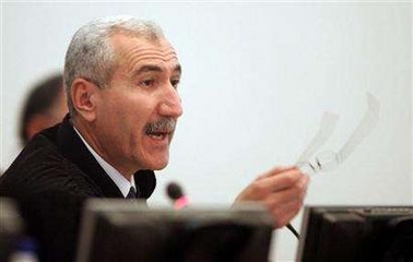 Presiding Judge Rizgar Mohammed Amin speaks to the court at the trial of Saddam Hussein and seven of his aides in Baghdad in this December 5, 2005 file photo.