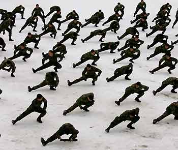 South Korean members of the Special Warfare Command stretch out on snow during an annual severe winter season drill in Pyongchang, about 180 km (113 miles) east of Seoul, January 16, 2006. 