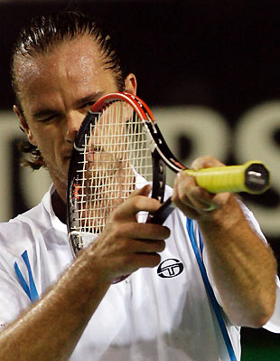 Xavier Malisse of Belgium aims his raquet towards a linesman during his match against Thomas Johansson of Sweden at the Australian Open tennis tournament in Melbourne January 18, 2006. [Reuters]