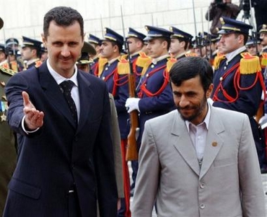 Iranian President Mahmoud Ahmadinejad, right, and Syrian President Bashar Assad review an honour guard at the Ash Shaeb presidential palace in Damascus Thursday Jan. 19, 2006.