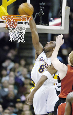 Los Angeles Lakers' Kobe Bryant dunks during the first half of their NBA game against the Toronto Raptors in Los Angeles January 22, 2006. Bryant scored 81 points to set a personal single-game scoring record, and the performance is the second-highest single-game scoring total in NBA history.