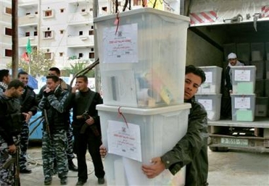 Palestinian policemen stand around as ballot boxes are unloaded at a warehouse before being distributed to polling stations in the southern Gaza Strip town of Rafah Tuesday Jan. 24, 2006.