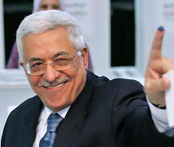 Palestinian President Mahmoud Abbas shows his marked finger after casting his vote at Palestinian Authority headquarters in the West Bank city of Ramallah January 25, 2006. 