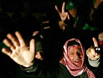 Supporters of Hamas gesture after polls closed in a Palestinian election in the West Bank city of Hebron January 25, 2006.