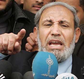 Senior Hamas leader Mahmoud al-Zahar speaks to journalists after he casts his ballots in Gaza City, January 25, 2006.