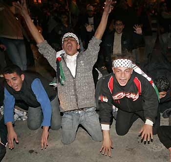 Supporters of the Fatah movement chant slogans after polling stations closed for the Palestinian elections in Gaza City January 25, 2006. 