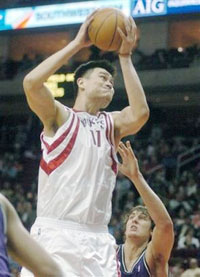Houston Rockets' Yao Ming (11), of China, holds up the ball high after catching an inbound pass over Milwaukee Bucks' Jiri Welsch, of the Czech Republic, during the fourth quarter of an NBA basketball game Wednesday, Feb. 1, 2006, in Houston. The Rockets won 86-84. (AP