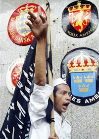 An Indonesian Muslim militant shouts a slogan in front of a building housing the Danish embassy in Jakarta February 3, 2006.