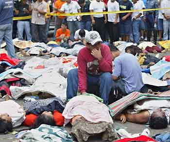 Victims of a stampede lie on a street in Manila February 4, 2006. Sixty-six people were killed in a stampede at a stadium in the Philippine capital, Manila, on Saturday as they lined up to get tickets for a popular television gameshow, police and local officials said.