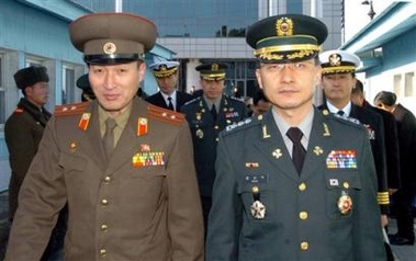 South Korean Army Col. Moon Sung-wook, right, is escorted by an unidentified North Korean officer at the border village of Panmunjom in North Korea, Friday, Feb. 3, 2006.