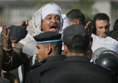 A relative shouts at police outside the port in Safaga in Egypt Sunday, Feb. 5, 2006 as friends and relatives continue to wait for news both of the victims and survivors of the ferry sinking on Friday in which 401 of almost 1300 passengers have so far been confirmed to have survived.