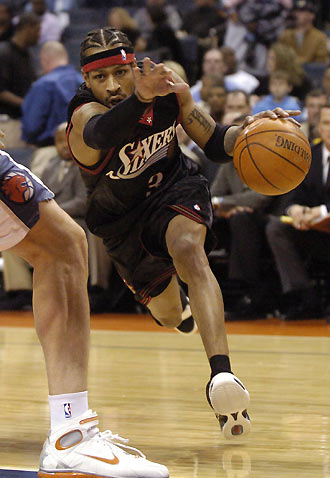 Philadelphia 76ers guard Allen Iverson uses his hand to clear his way around Charlotte Bobcats center Primoz Brezec during NBA action at Bobcats Arena in Charlotte, North Carolina February 8, 2006. 