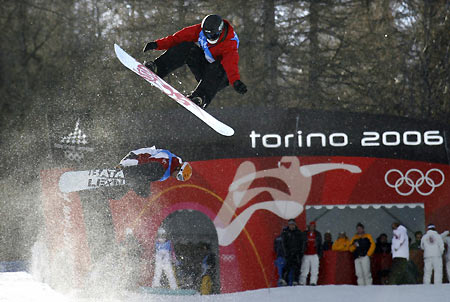 Gian Simmen of Switzerland (top) trains during a practice session in the half pipe snowboarding competition at the Torino 2006 Winter Olympic Games in Bardonecchia, Italy, February 8, 2006.