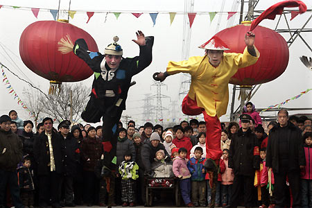 Chinese dancers on stilts perform during a Lantern Festival celebration in Beijing February 12, 2006. Lantern Festival marks the last day of the 15-day long Spring Festival, the most important festival of the year in China. [Reuters]