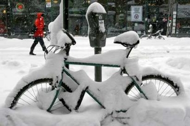 Snow accumulates on a bicycle during a snowstorm in New York February 12, 2006. 