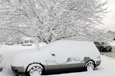 Snow covers a car and tree in Waldorf, Md., Sunday, Feb. 12, 2006.