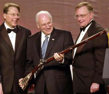 Vice President Dick Cheney, center, accepts a rifle from National Rifle Association President Kayne Robinson, right, and NRA Vice President Wayne R. LaPierre, after concluding his keynote address to the 133rd annuanl NRA convention in this April 17, 2004 file photo in Pittsburgh. Cheney accidentally shot and injured a man during a weekend quail hunting trip in Texas, his spokeswoman said Sunday Feb. 12, 2006. (AP 