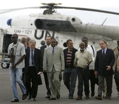 Haitian presidential candidate Rene Preval, second right, listens to U.N. special envoy to Haiti Juan Gabriel Valdes, right, upon his arrival from his hometown of Marmelade to the U.N. base in Port-au-Prince, Haiti, Monday, Feb. 13, 2006. 