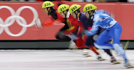 Takafumi Nishitani (236) from Japan, Li Haonan (214) from China, Rusty Smith (255) from the U.S., Fabio Carta (229) from Italy compete in the men's 5000 metres short track speed skating relay semi-finals at the Torino 2006 Winter Olympic Games in Turin, Italy, February 15, 2006. [Reuters]