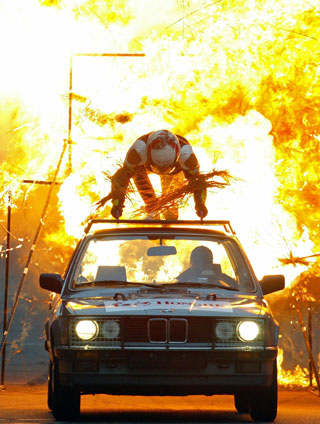 A Hollywood stunt actor performs a stunt atop a car driving through fire at the Shanghai International Circuit March 12, 2006. The Hollywood stunt team started their tour of China and performed during the intermissions of the 2006 China Circuit Championship on Sunday.