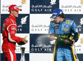 Winner of the Bahrain Formula One Grand Prix Renault's Fernando Alonso of Spain (R) and Ferrari's Michael Schumacher of Germany spray non-alcoholic sparkling wine at the end of the race at the Sakhir racetrack in Manama March 12, 2006. [Reuters]