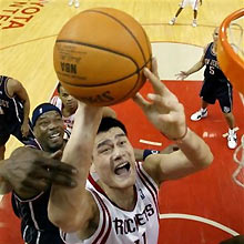 New Jersey Nets' Clifford Robinson, left, fouls Houston Rockets' Yao Ming, of China, as Ming shoots in the first quarter of an NBA basketball game, Monday, March 13, 2006, in Houston.