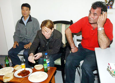 Three abducted foreigners, Young Yong of South Korea (L), Alfred Yacobzadeh (R) of France and Caroline Simon of France, are seen after being kidnapped by militants from the Popular Front for the Liberation of Palestine southern in Gaza Strip March 14, 2006. U.N. Secretary-General Kofi Annan called on Tuesday for the release of foreigners kidnapped by Palestinians in the Gaza Strip after Israel raided a West Bank prison. REUTERS/Ibraheem Abu Mustafa