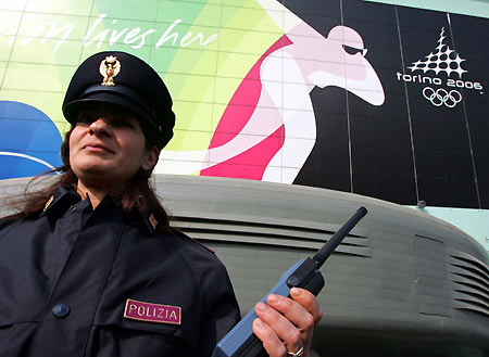 An italian policeman inspects a bus as it enters the Palavela venue for the Torino 2006 Winter Olympic Games in Turin. [Reuters]