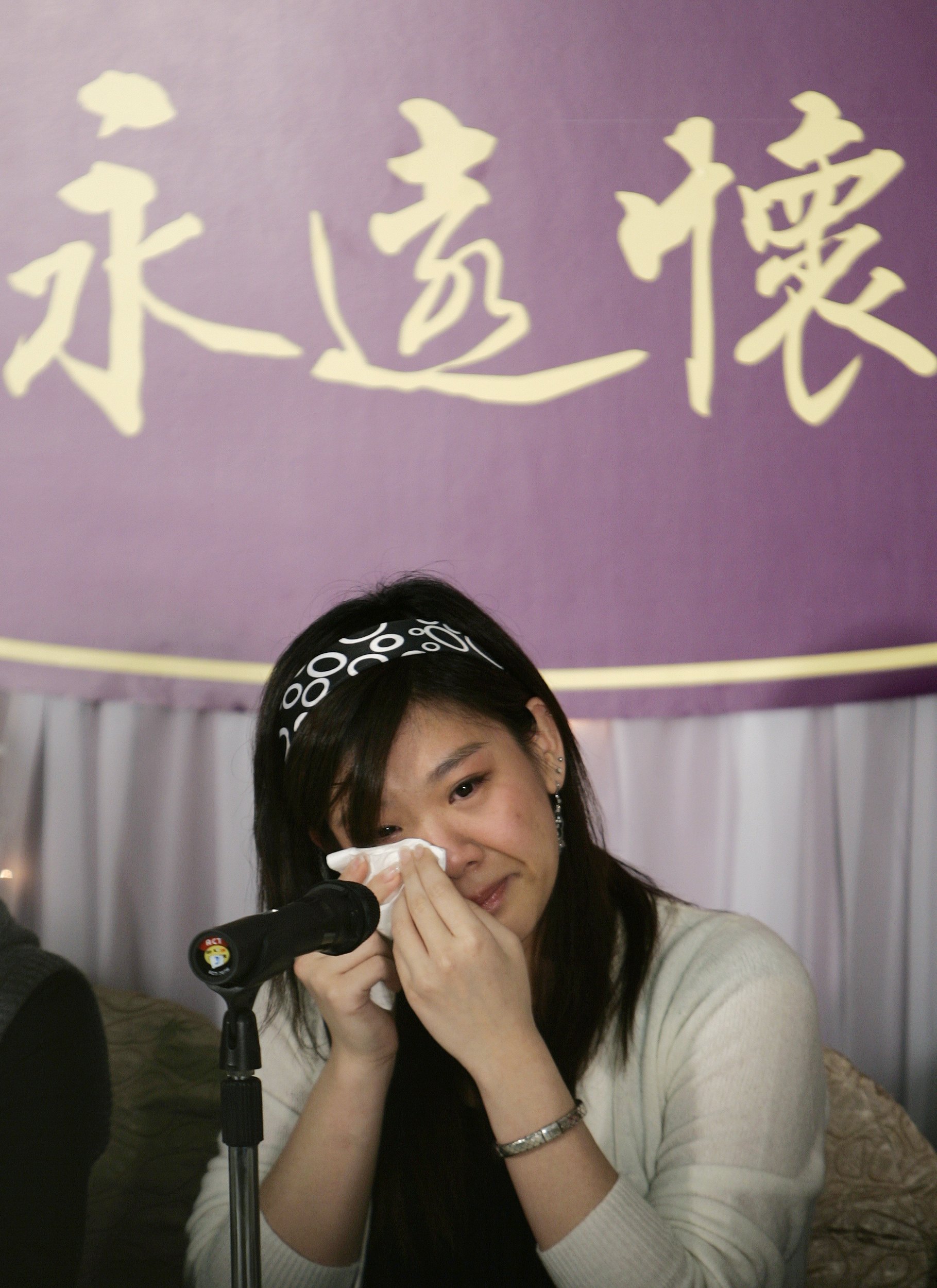 Lydia Shum's daughter cries during news conference