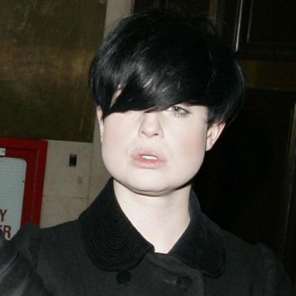 Blushing beach babe Kelly Osbourne